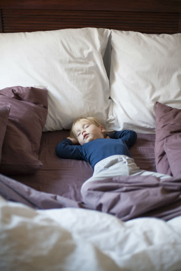 child on mattress topper